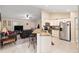Open kitchen with stainless steel appliances, granite counters, and breakfast bar seating at 13581 Sw 48Th Ct, Ocala, FL 34473