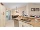 Bright kitchen featuring granite countertops, white cabinetry, and a view to the dining area at 13581 Sw 48Th Ct, Ocala, FL 34473