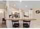 Bright kitchen featuring granite countertops, white cabinetry, and a breakfast bar area at 13581 Sw 48Th Ct, Ocala, FL 34473