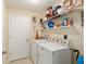 Functional laundry room with modern washer and dryer units with shelving at 13581 Sw 48Th Ct, Ocala, FL 34473