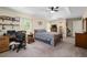Spacious main bedroom featuring a tray ceiling, fan, a desk and adjacent ensuite at 13581 Sw 48Th Ct, Ocala, FL 34473