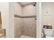 Tiled walk-in shower features neutral-toned tile and decorative mosaic inlay at 13581 Sw 48Th Ct, Ocala, FL 34473
