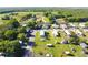 Overhead view of a community with well-maintained lawns, mature trees, and a winding street at 2514 Sea Oats N Cir, Lakeland, FL 33815