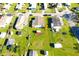 Aerial view of residential properties with green lawns and a red shed in the back at 2514 Sea Oats N Cir, Lakeland, FL 33815
