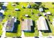Aerial view of a neighborhood featuring multiple residential homes with green lawns and paved roads at 2514 Sea Oats N Cir, Lakeland, FL 33815