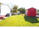 View of the back yard and shed featuring green grass and an air conditioning unit at 2514 Sea Oats N Cir, Lakeland, FL 33815
