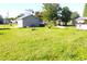 Wide shot of backyard showing the large green lawn and an additional shed with ample space for activities at 2514 Sea Oats N Cir, Lakeland, FL 33815