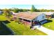 Inviting single-story home featuring a long, covered front porch and well-maintained green lawn at 2514 Sea Oats N Cir, Lakeland, FL 33815