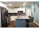 Open kitchen with stainless steel appliances, granite countertops, center island, and tile backsplash at 2514 Sea Oats N Cir, Lakeland, FL 33815