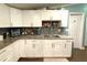 Kitchen with modern appliances, granite countertops, tile backsplash and white cabinets at 2514 Sea Oats N Cir, Lakeland, FL 33815
