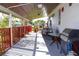 A spacious covered porch including outdoor seating, dining and barbecue area with plenty of space for entertaining at 2514 Sea Oats N Cir, Lakeland, FL 33815