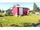 Exterior of the red storage shed situated in the backyard on a sunny day at 2514 Sea Oats N Cir, Lakeland, FL 33815