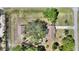 Aerial view of the property and outbuilding showcasing the layout of the home and surrounding landscape at 2971 Gardenia Dr, Indian Lake Estates, FL 33855
