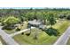 Aerial view of a beautifully landscaped home with a spacious yard and surrounding lush greenery at 2971 Gardenia Dr, Indian Lake Estates, FL 33855