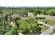 Scenic aerial view of the property, lush greenery, and the surrounding neighborhood at 2971 Gardenia Dr, Indian Lake Estates, FL 33855