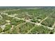 Expansive aerial view of a property nestled among lush trees and a serene landscape at 2971 Gardenia Dr, Indian Lake Estates, FL 33855