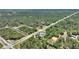 Aerial view showcasing property and surrounding wooded area at 2971 Gardenia Dr, Indian Lake Estates, FL 33855