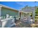 Back patio area featuring a generator and outdoor seating for relaxation and convenience at 2971 Gardenia Dr, Indian Lake Estates, FL 33855