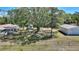 Expansive backyard with mature trees, a storage shed, and a fenced perimeter, perfect for outdoor enjoyment at 2971 Gardenia Dr, Indian Lake Estates, FL 33855