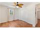 Cozy bedroom with wood floors, a ceiling fan, and a spacious closet at 2971 Gardenia Dr, Indian Lake Estates, FL 33855