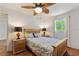 Cozy bedroom with a wooden bed frame, side tables, lamps, and a sunny window, offering a relaxing atmosphere at 2971 Gardenia Dr, Indian Lake Estates, FL 33855