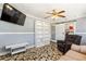 Bonus room with unique tile flooring, a ceiling fan, and a large bookcase at 2971 Gardenia Dr, Indian Lake Estates, FL 33855