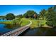 Scenic bridge over a tranquil lake surrounded by lush greenery and mature trees at 2971 Gardenia Dr, Indian Lake Estates, FL 33855