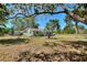 Charming single-story home with a well-manicured lawn, mature trees, and inviting curb appeal at 2971 Gardenia Dr, Indian Lake Estates, FL 33855