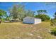 A detached, white garage with lush surroundings on a big lot at 2971 Gardenia Dr, Indian Lake Estates, FL 33855