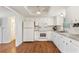 Bright kitchen featuring white cabinets, granite countertops, and modern appliances at 2971 Gardenia Dr, Indian Lake Estates, FL 33855