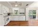 Bright kitchen with white cabinetry, granite counters, and a seamless transition to the backyard at 2971 Gardenia Dr, Indian Lake Estates, FL 33855