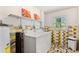 Laundry room featuring vibrant tilework, a washer and dryer, and ample shelving at 2971 Gardenia Dr, Indian Lake Estates, FL 33855