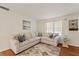 Bright living room featuring a comfortable beige sectional sofa and a neutral patterned rug at 2971 Gardenia Dr, Indian Lake Estates, FL 33855