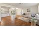 Open-concept living space featuring wood floors, a comfortable sofa, and a view into the backyard at 2971 Gardenia Dr, Indian Lake Estates, FL 33855