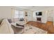 Bright living room with a fireplace, wood floors, large sofa, and natural light at 2971 Gardenia Dr, Indian Lake Estates, FL 33855