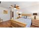 Comfortable bedroom with wood floors, ceiling fan, and a neutral color palette at 2971 Gardenia Dr, Indian Lake Estates, FL 33855