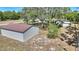 View of the large outbuilding with metal roof in the backyard at 2971 Gardenia Dr, Indian Lake Estates, FL 33855