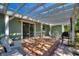 Cozy outdoor patio with a pergola, tile flooring, and comfortable seating area perfect for entertaining at 2971 Gardenia Dr, Indian Lake Estates, FL 33855