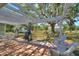 Spacious back patio with white pergola, ideal for enjoying serene outdoor activities at 2971 Gardenia Dr, Indian Lake Estates, FL 33855