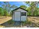View of small shed featuring a side door and window, providing extra storage space on the property at 2971 Gardenia Dr, Indian Lake Estates, FL 33855