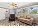 Relaxing room featuring a cozy chair and sofa, with a view of the laundry area and windows at 2971 Gardenia Dr, Indian Lake Estates, FL 33855