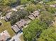 An aerial perspective showcases a home surrounded by lush trees and a well-manicured lawn at 4524 Oak Arbor Cir, Orlando, FL 32802
