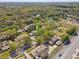 An aerial view of a neighborhood with mature trees and a nearby pond at 4524 Oak Arbor Cir, Orlando, FL 32802