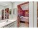 Bathroom featuring a mirrored wall, vanity, and decorative beaded doorway to the bedroom at 4524 Oak Arbor Cir, Orlando, FL 32802