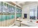 Bathroom featuring a shower with tropical-themed curtain, vanity, and bright lighting at 4524 Oak Arbor Cir, Orlando, FL 32802