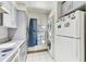Functional kitchen area featuring a washer/dryer unit and a refrigerator near ample counter space at 4524 Oak Arbor Cir, Orlando, FL 32802
