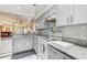 Bright kitchen with gray cabinets, granite countertops, and modern appliances at 4524 Oak Arbor Cir, Orlando, FL 32802