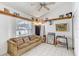Cozy living room featuring tile floors, high ceilings, and natural light from a large window at 4524 Oak Arbor Cir, Orlando, FL 32802