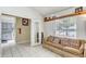 Comfortable living room with tile flooring, doorway to kitchen, and bright natural light at 4524 Oak Arbor Cir, Orlando, FL 32802