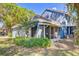 Home's rear exterior features a screened porch and tropical landscaping in the backyard at 4524 Oak Arbor Cir, Orlando, FL 32802